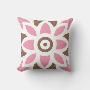 a pink flower on a brown background cushion