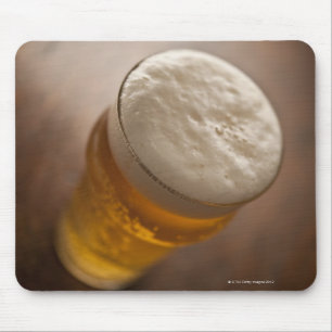 A pint of lager, back lir shallow focus rustic mouse pad