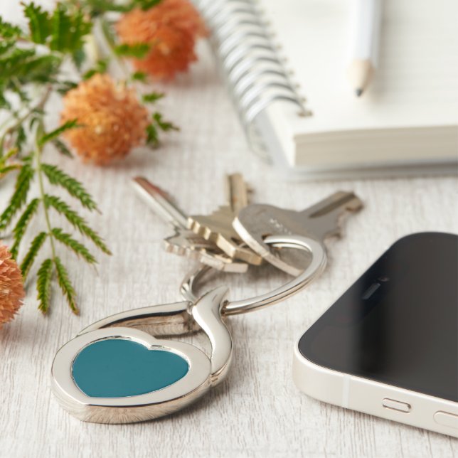 A plain teal background fills the image key ring (Side)