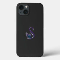 a purple and green peacock feather on a black back