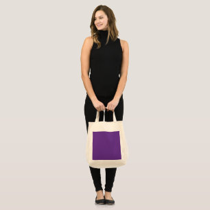 a purple background with a white border tote bag