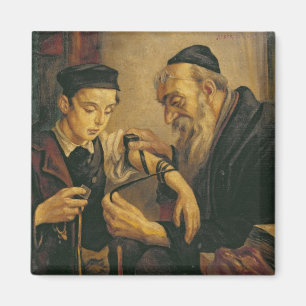 A Rabbi tying the Phylacteries to the arm of a boy Magnet