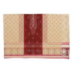 a red and beige carpet with a red border pillowcase