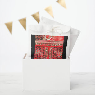 a red and green floral design on a black backgroun favour bag
