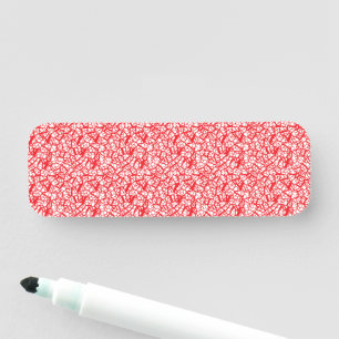 a red and white background with small white dots name tag