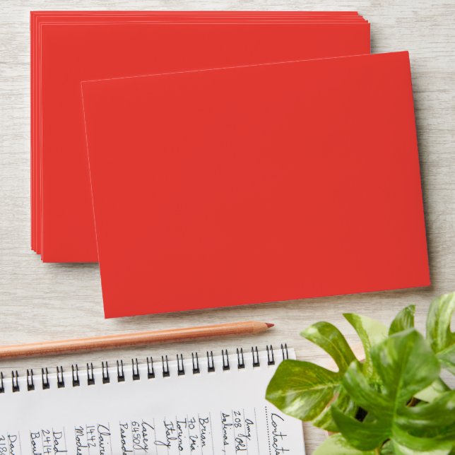 a red background with a white border envelope (Stacked)