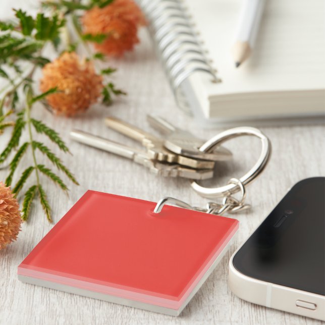 a red background with a white border key ring (Front Right)