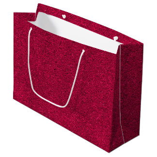 A red glittery gift bag with white handles