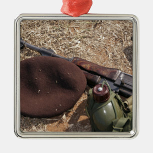 A rifle, military cover and canteen metal ornament