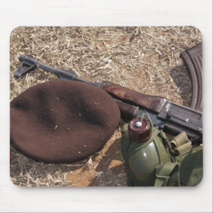 A rifle, military cover and canteen mouse pad