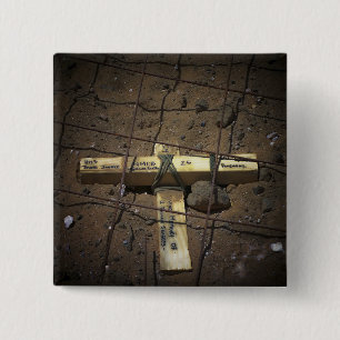 A road repair crew places a cross 15 cm square badge