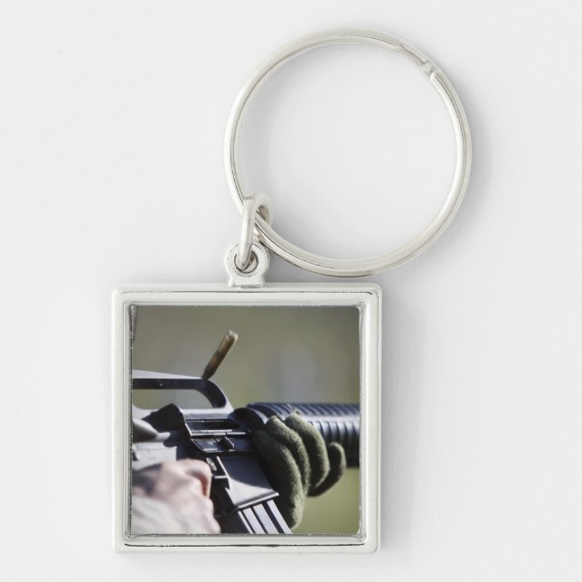 A round flies from the chamber of an M-16A2 Key Ring (Front)