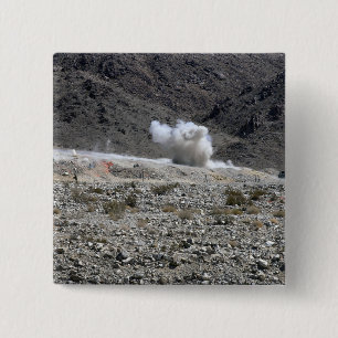 A round from an AT-4 small rocket launcher 15 Cm Square Badge