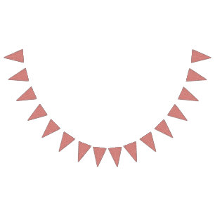 A rug with a red and pink motif features a decorat bunting