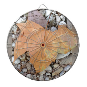 a rusty leaf on pebbles dartboard