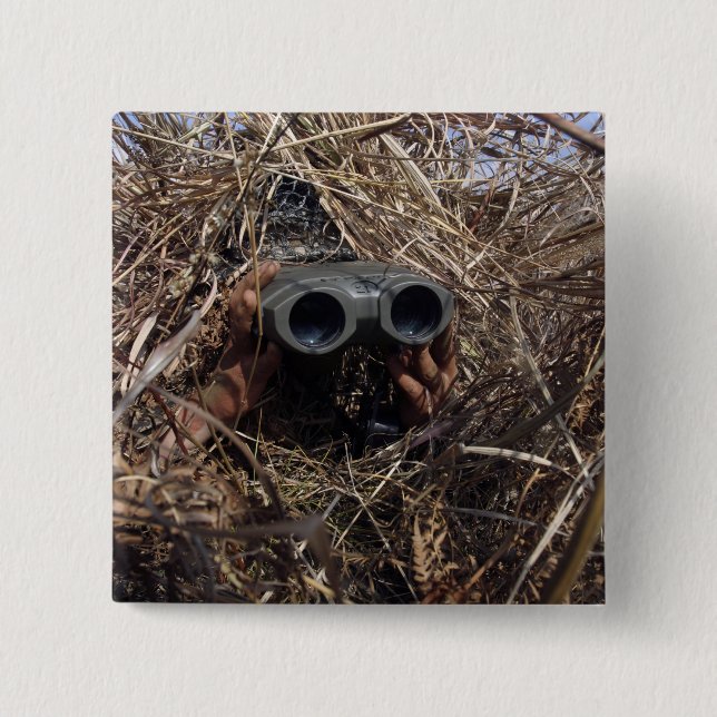 A scout observer practices observation techniqu 15 cm square badge (Front)