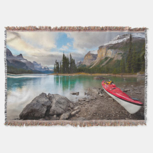 A sea kayak ashore at Spirit Island Throw Blanket