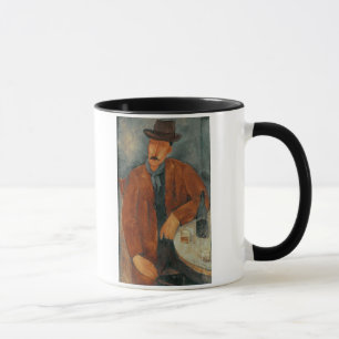 A seated man leaning on a table mug