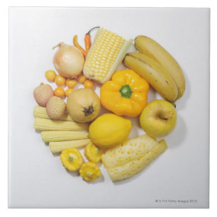 A selection of yellow fruits & vegetables. ceramic tile
