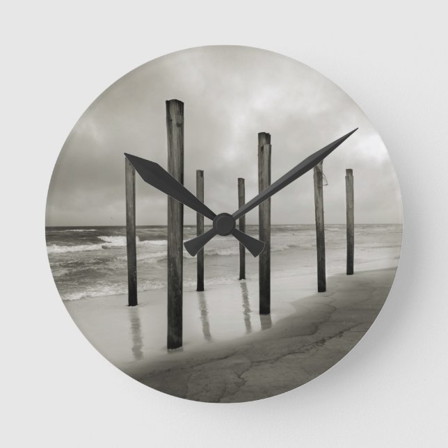 A sepia toned shot of old beach posts round clock (Front)