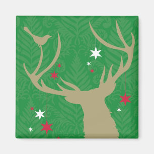 A silhouette of a deer with stars hanging from its magnet