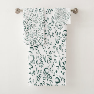 A silver drop splashes into a pool of white liquid bath towel set