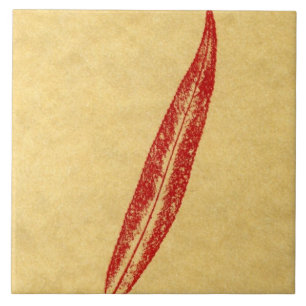 A single willow leaf printed in red on tan paper ceramic tile