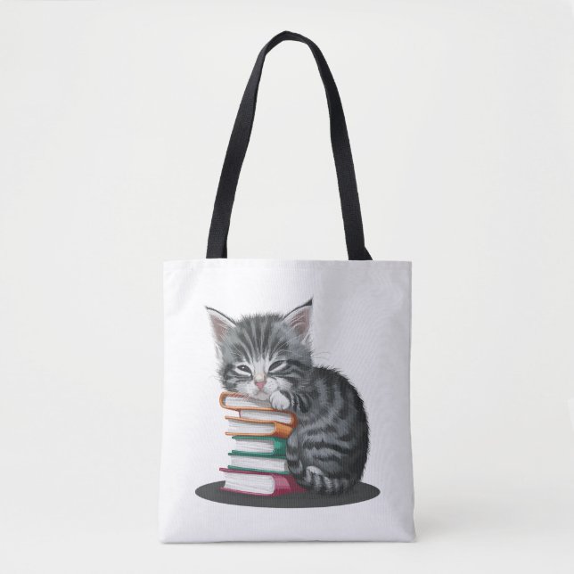 A sleepy kitten cuddled up with a stack of books. tote bag (Front)