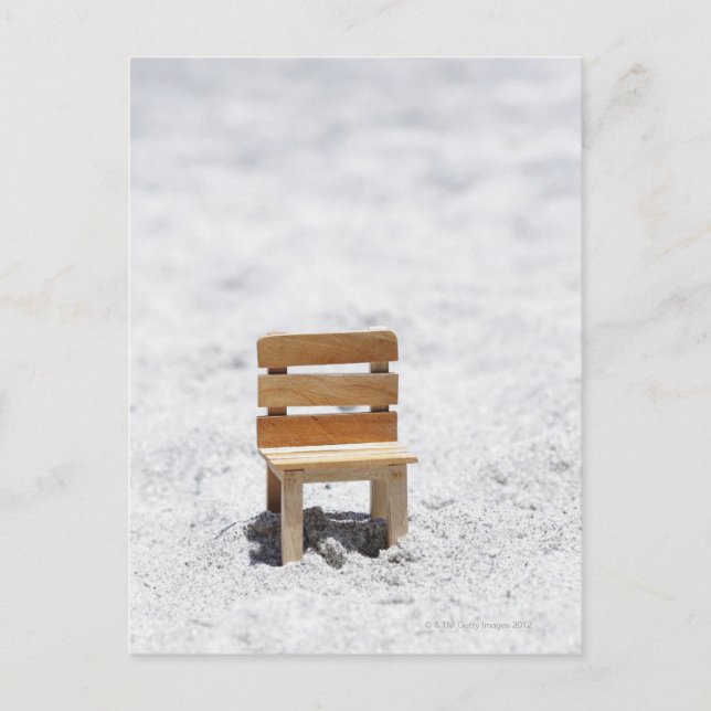 A small chair in the sandy beach postcard (Front)