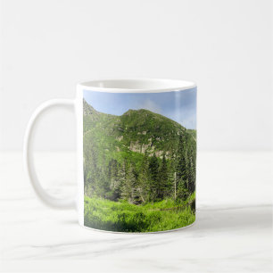 A small pond in the valley of the mountains in the coffee mug
