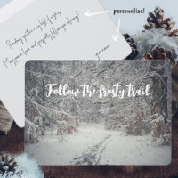 A snow-covered path through a winter forest