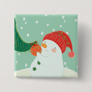 A snowman hanging an ornament on a tree 15 cm square badge