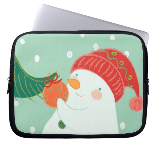 A snowman hanging an ornament on a tree laptop sleeve (Front)