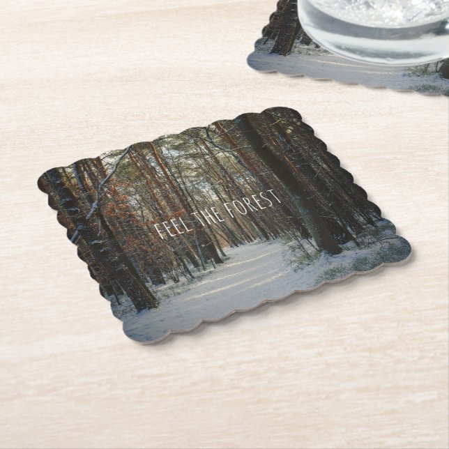 A snowy trail in a winter pine forest paper coaster (Angled)