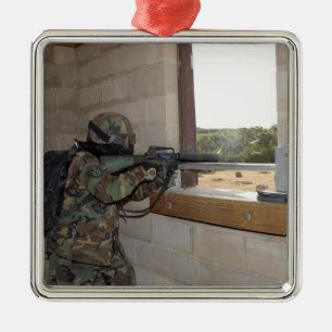 A soldier acts as an opposition force metal tree decoration