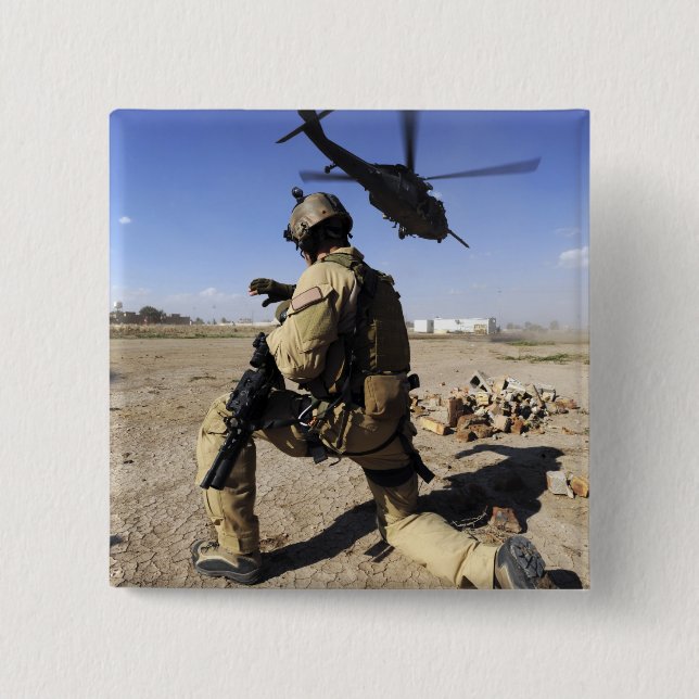 A soldier conducts security for an HH-60 15 Cm Square Badge (Front)