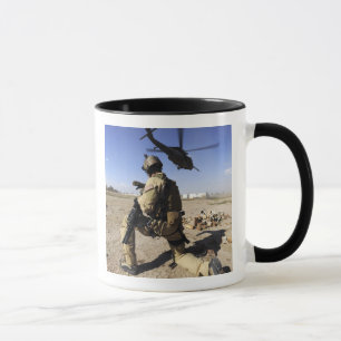 A soldier conducts security for an HH-60 Mug