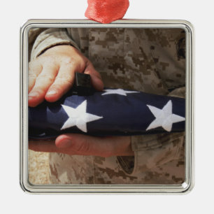A soldier holds the United States flag Metal Ornament