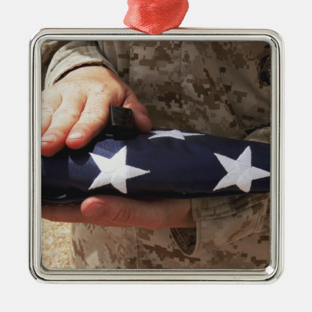 A soldier holds the United States flag Metal Ornament (Front)