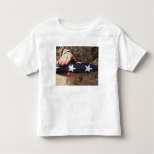 A soldier holds the United States flag Toddler T-Shirt