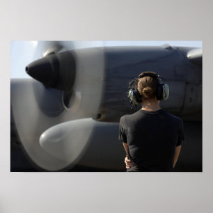 A soldier monitors the performance poster