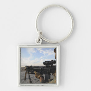 A soldier sights in to fire on a target key ring
