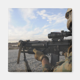 A soldier sights in to fire on a target magnet
