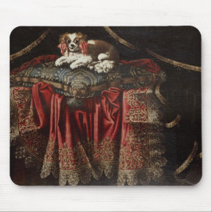 A spaniel seated on an embroidered cushion mouse pad