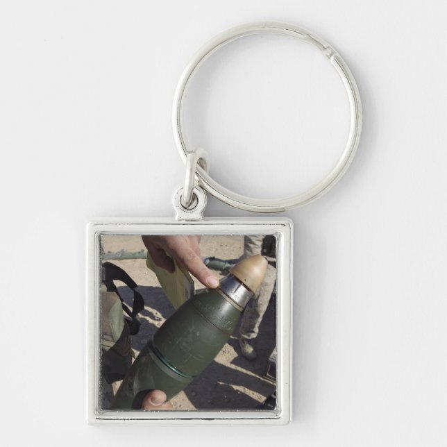 A squad leader points to a delay setting key ring (Front)