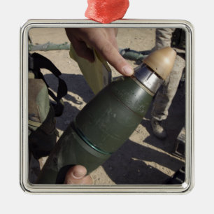 A squad leader points to a delay setting metal ornament
