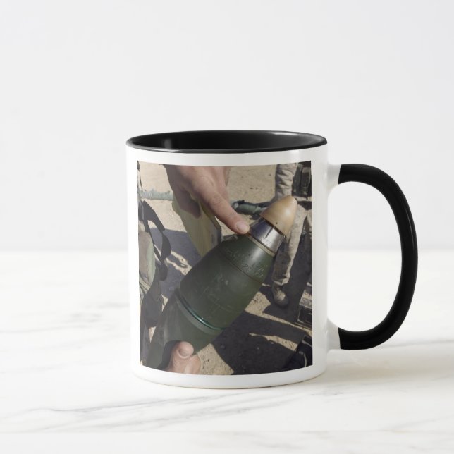 A squad leader points to a delay setting mug (Right)