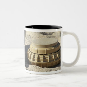A static display of a converted ordnance shell Two-Tone coffee mug