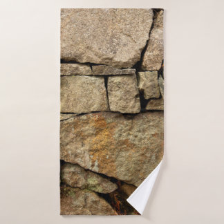 A stone wall made of cobblestones background textu bath towel