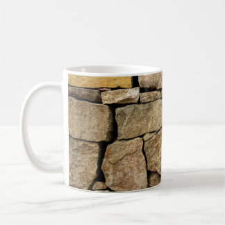 A stone wall made of cobblestones background textu coffee mug